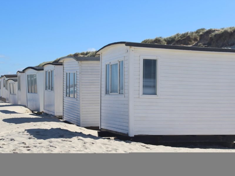 A row of white cabins on the Lokken beach, Denmark